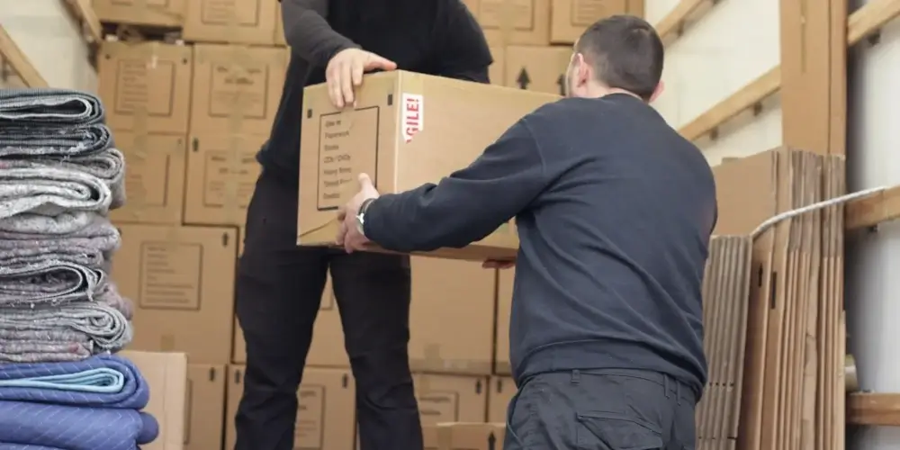 Removal men loading the van